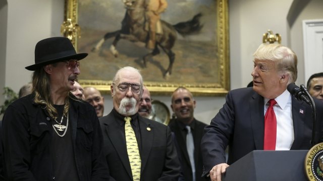 President Donald Trump signs the Music Modernization Act in the company of Kid Rock and other musicians in October 2018