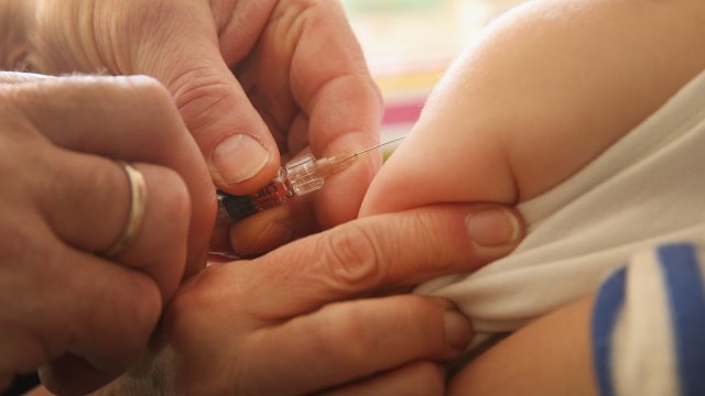 Doctor vaccinates baby