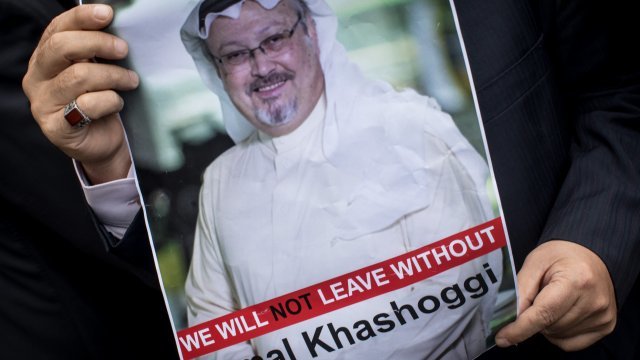 Man holds poster of Jamal Khashoggi