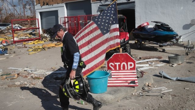 A firefighter walks in front of a home wrecked by Hurricane Michael