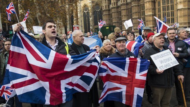 Protestors holding UK flags.
