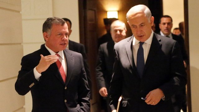 King Abdullah II (left) walks with Prime Minister Benjamin Netanyahu (right)