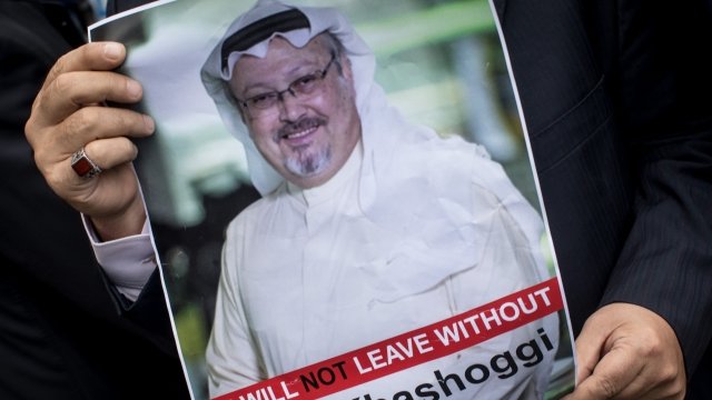 A man holds a poster of journalist Jamal Khashoggi