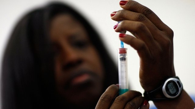 A nurse holds a flu shot