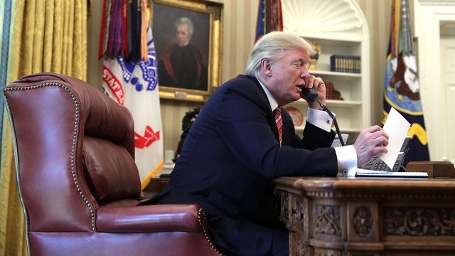 President Donald Trump talks on the phone
