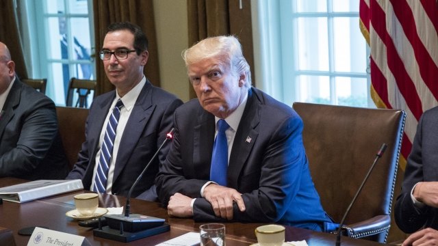 U.S. President Donald Trump sits with Steve Mnuchin during a bilateral meeting at the White House