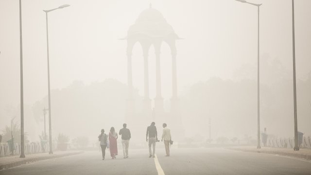 People walk through heavy pollution