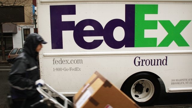 A FedEx employee delivers packages