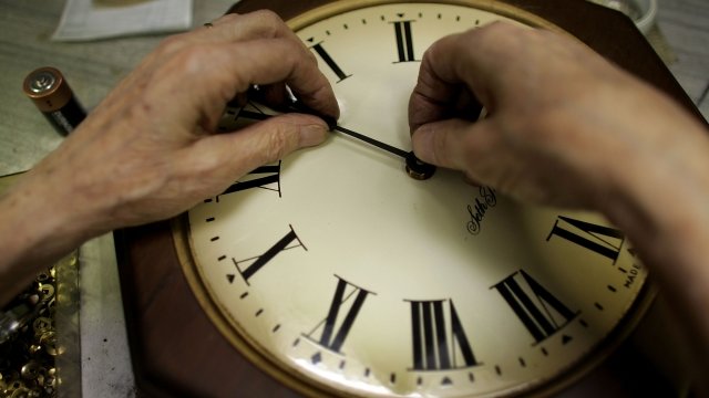 A man repairs a clock at a store in in Plantation, Florida