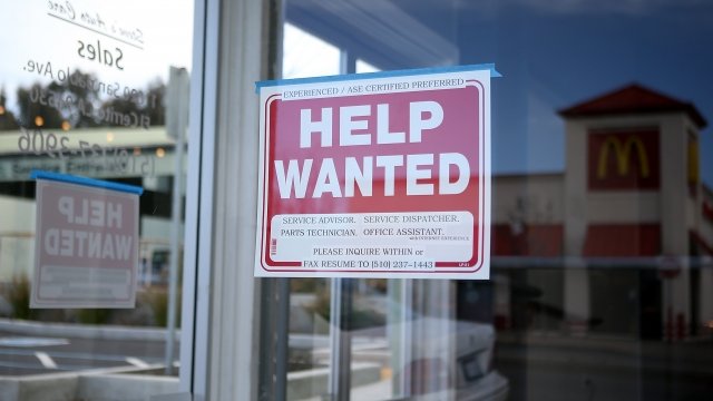 'Help Wanted' sign in a storefront window