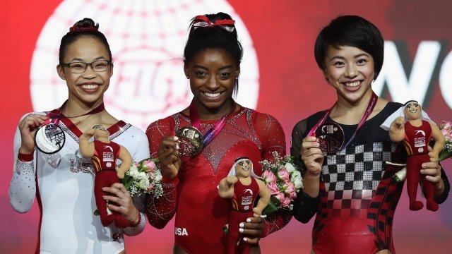 Simone Biles holds a gold medal at the Gymnastics World Championships