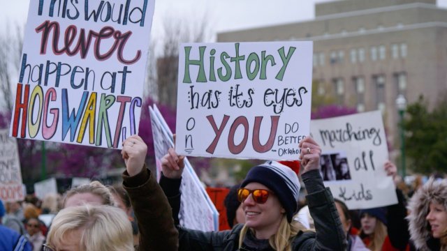 Protesters march in front of the Oklahoma State Capitol.