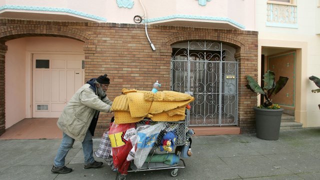 Homeless man pushes his cart in San Francisco