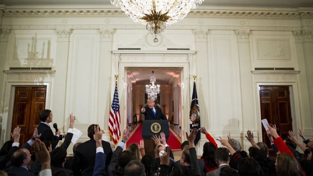 President Donald Trump points to reporters during a press conference after the 2018 midterm elections