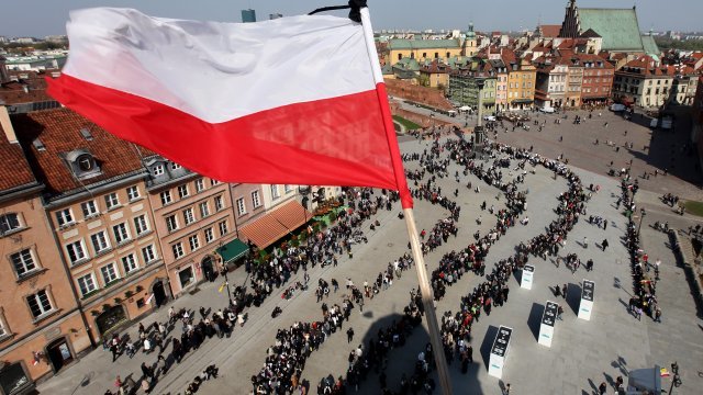 The Polish flag flies over Warsaw