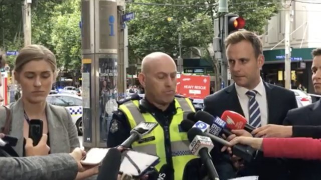 Victoria police speak to reporters.