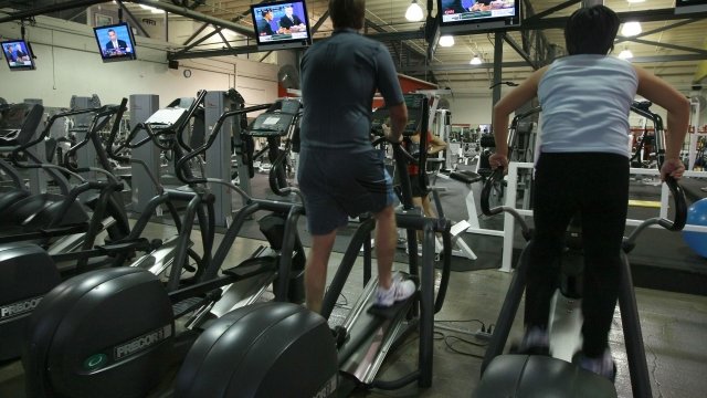 People exercising on an elliptical machine