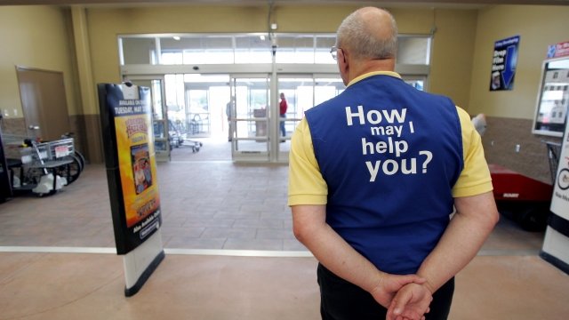 Walmart employee greets customers