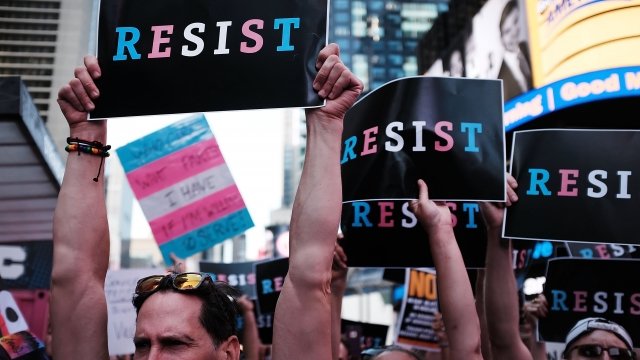 People protest the president's ban on transgender people serving in the military