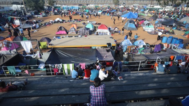 People rest at a camp near the U.S.-Mexico border.