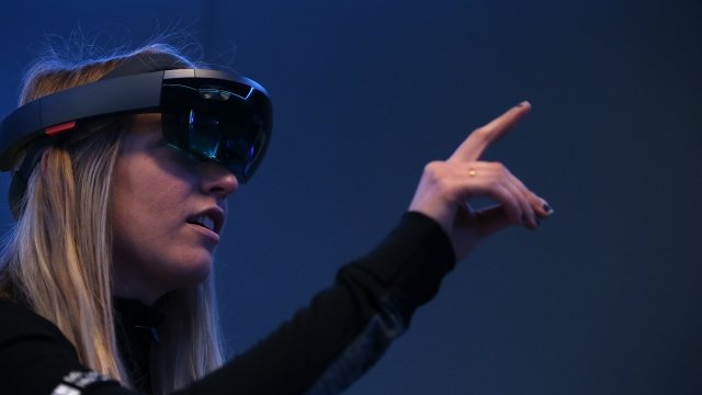 A woman uses a Microsoft HoloLens headset