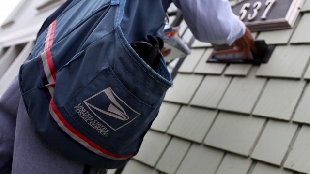 USPS letter carrier delivers mail
