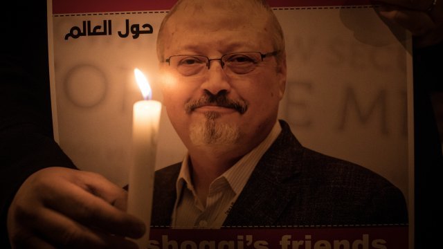 A person holds a candle at a vigil for Jamal Khashoggi
