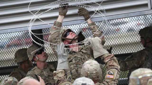 Troops set up up concertina wire at the international bridge with Mexico