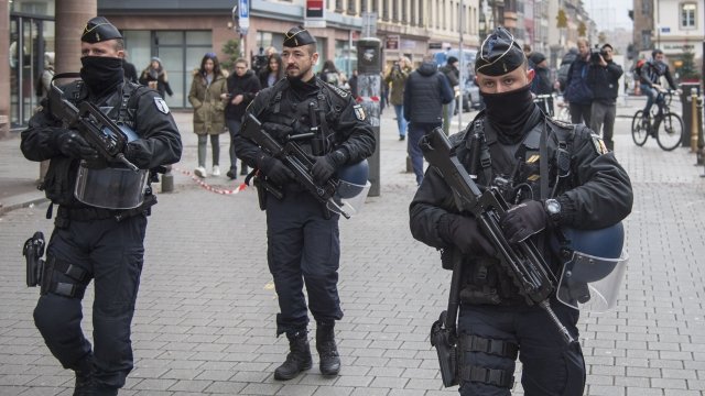 Armed officers patrol near the site of an attack in Strasbourg, France