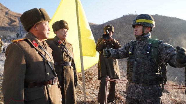 North and South Korean soldiers talk during an inspection