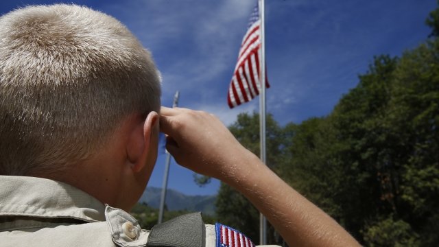 Boy Scout salutes the American flag.