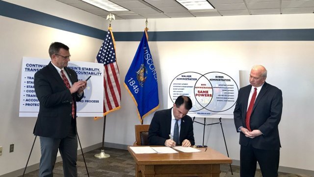 Wisconsin Gov. Scott Walker signs bills.