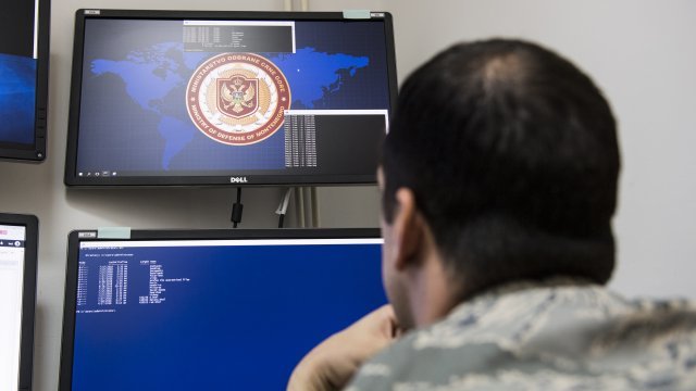 A U.S. Cyber Command airman looks at a simulated cyber threat on a computer monitor.