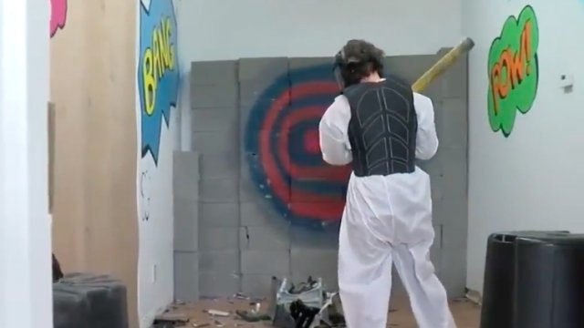 A patron smashes objects at a popular smash room.