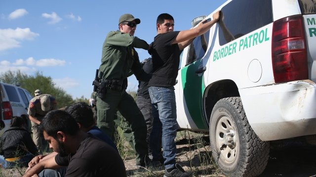 A Border Patrol agent searches a man