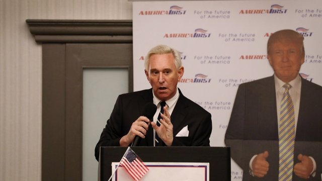 Roger Stone giving a speech in front of a cardboard cutout of Donald Trump
