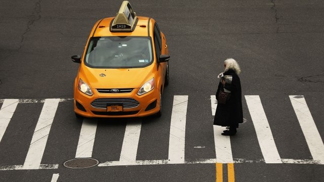 A woman walks through a Manhattan intersection in New York City.