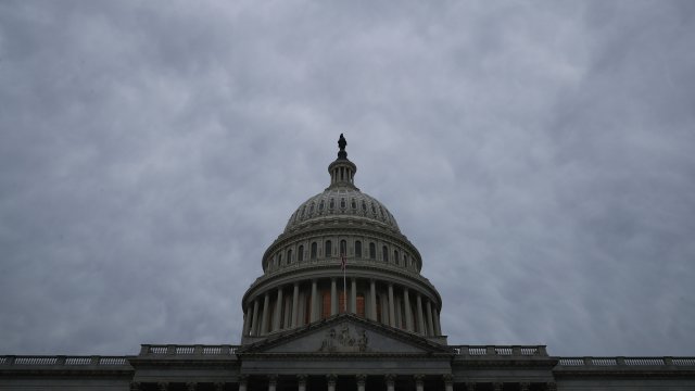 The U.S. Capitol dome stands under a cloudy sky.