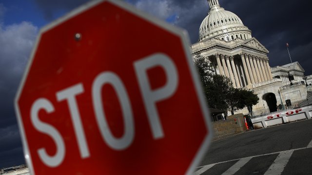 The U.S. Capitol is shown on January 24, 2018 in Washington, DC, with a STOP sign in front of it.
