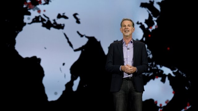 Netflix CEO Reed Hastings in front of map.
