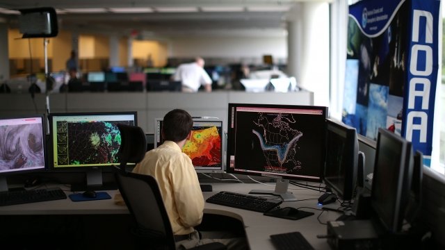 A NOAA meteorologist monitors weather in the agency's Center for Weather and Climate Prediction
