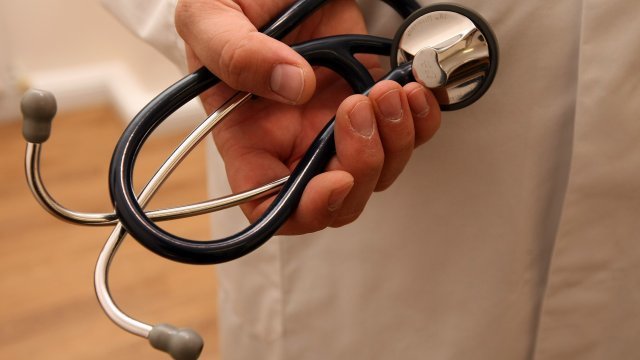A doctor holds a stethoscope
