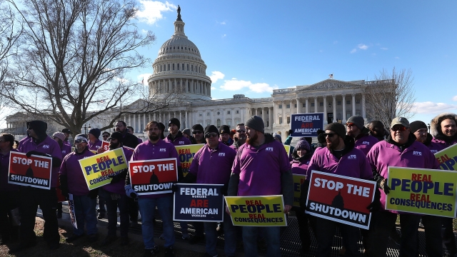 People rally against the partial federal government shutdown outside the U.S. Capitol.