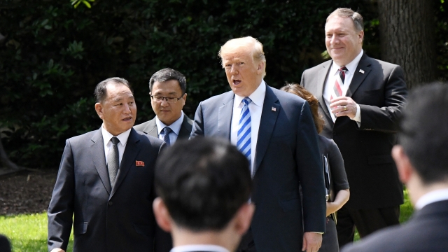 President Donald Trump walks with Kim Jong Un's envoy Kim Yong Chol and Secretary of State Mike Pompeo
