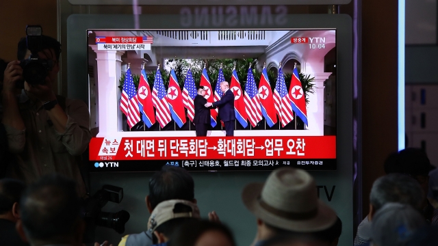 People watch President Trump's meeting with North Korean leader Kim Jong-un on TV