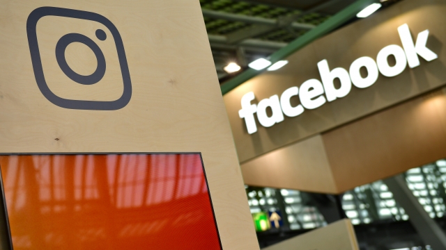 The Instagram and Facebook logos on display at a tech trade show