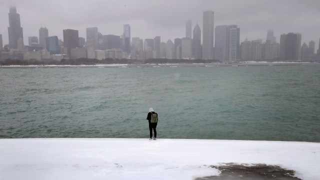 Man stands in snow in front of Chicago