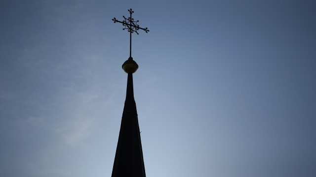 A cross on top of a Catholic church