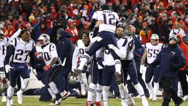 Tom Brady #12 of the New England Patriots celebrates with teammates.