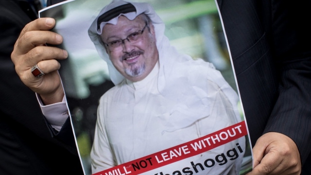 A person holds a flyer of journalist Jamal Khashoggi